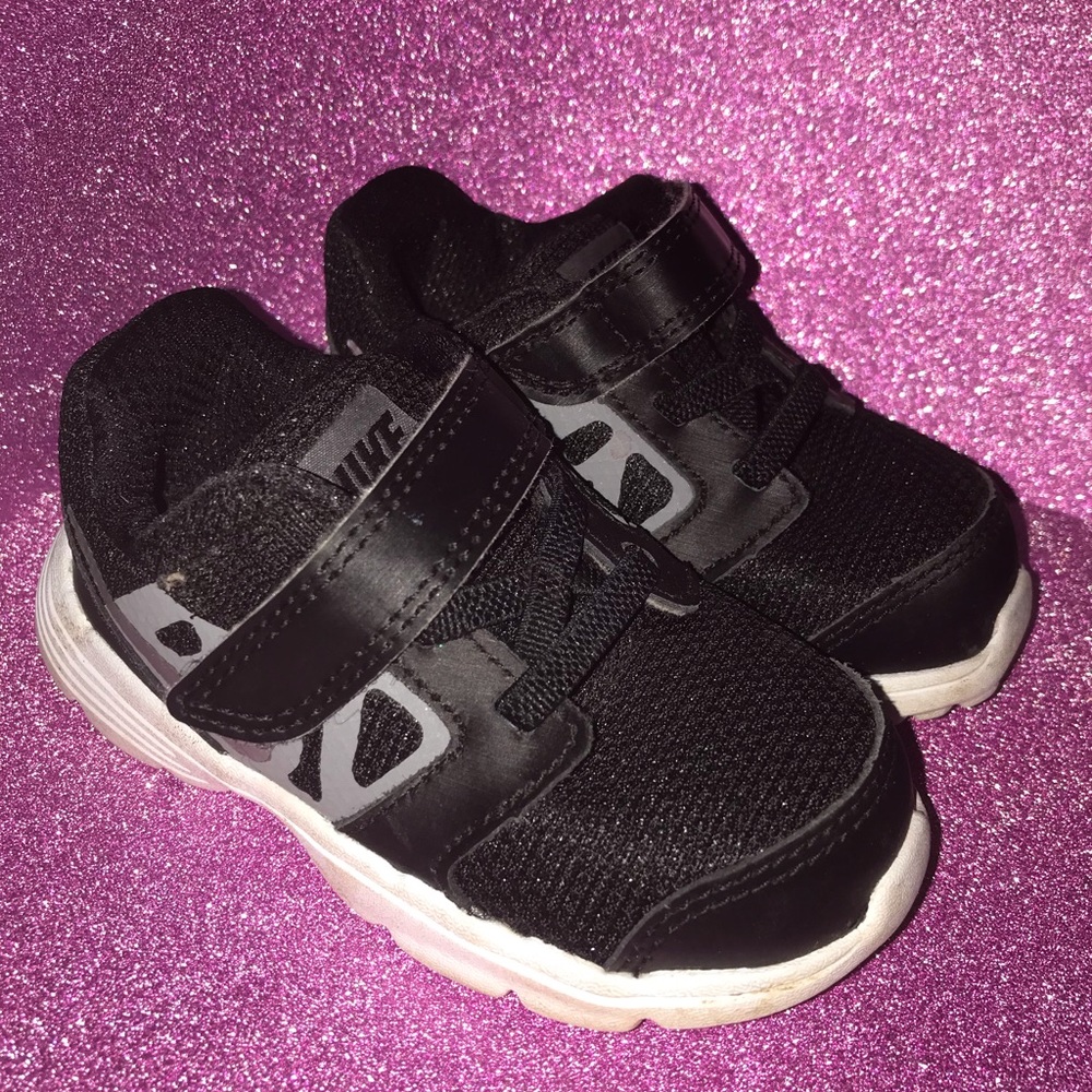 Kids strap across Nike shoes